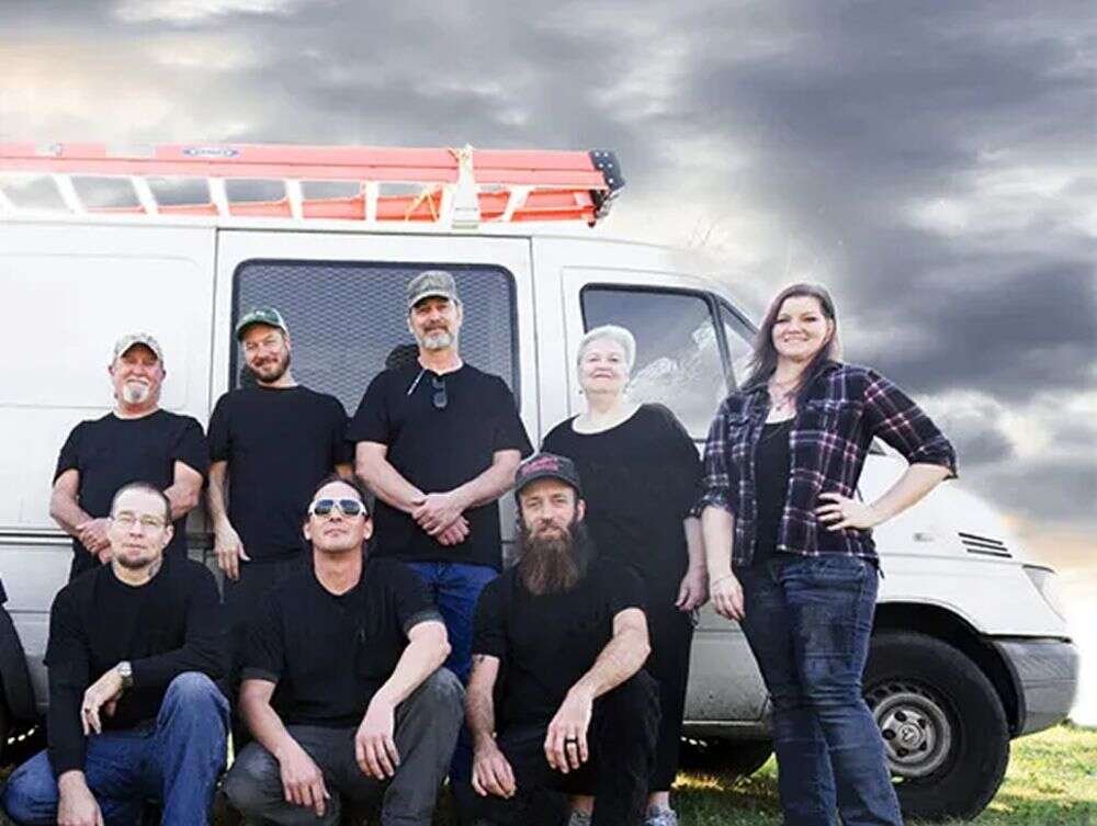 For Saving Home Services technicians standing in front of a company van