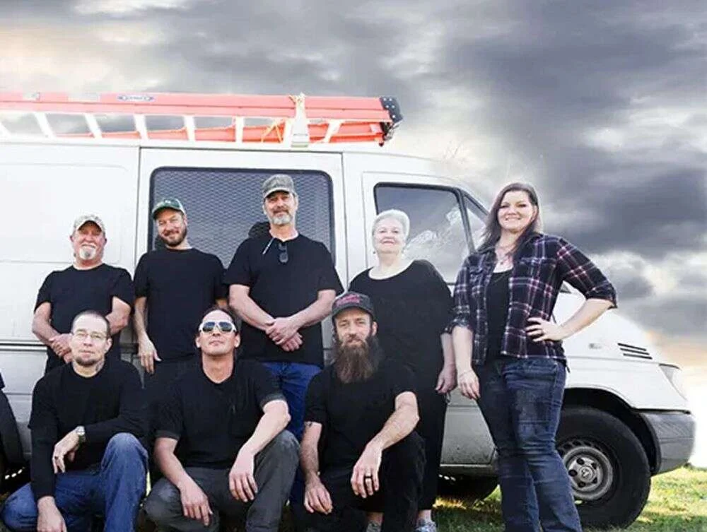 For Saving Home Services technicians standing in front of a company van For Saving Home Services technicians standing in front of a company van
